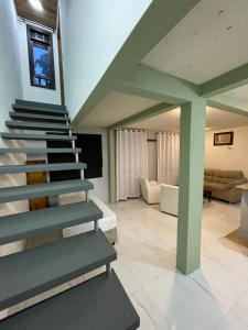 a staircase in a house with a living room at Pousada Ilha da Magia in Florianópolis