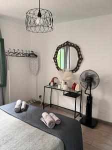 a bedroom with a bed and a mirror and a fan at RockBeach bungalow in Costa Teguise