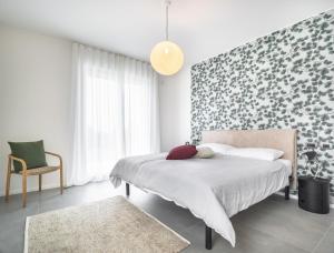 a bedroom with a bed with a floral accent wall at Villa Angelina in Lazise +27 photos