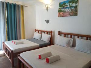 Postel nebo postele na pokoji v ubytování Jambo Kendwa Villa
