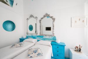 a bedroom with two beds and a blue dresser at La Bella Annacapri in Anacapri