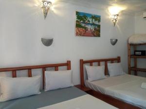 Postel nebo postele na pokoji v ubytování Jambo Kendwa Villa