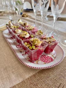 a plate of food on a table with wine glasses at La Parenthèse du Var - Chambre d'hôtes petits déjeuners inclus et terrasse ombragée in Saint Antonin du Var