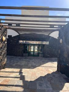 an entrance to a building with a stone wall at RockBeach bungalow in Costa Teguise