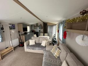 a living room with a couch and a kitchen at "Malton" LG27 Pet Friendly in Shanklin