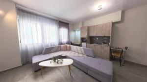 a living room with a couch and a table at Sidus Condos in Veria