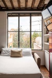 a bedroom with a bed and a large window at Monti apartment BDB in Rome