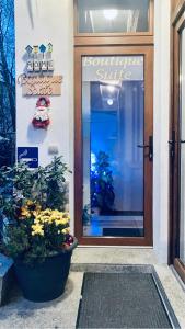 a front door of a store with a plant in front at Boutique Suite 2 in Cluj-Napoca