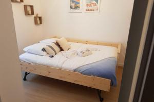 a bed with two pillows on it in a room at Nice and modern flat at the heart of Panier in Marseille - Welkeys in Marseille