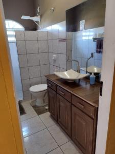a bathroom with a sink and a toilet at Hostel Da Ilha De Sao Francisco Do Sul in Marechal Luz