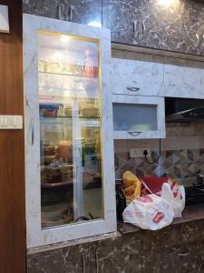 a cabinet in a kitchen with food inside of it at Palac Kragujevac in Kragujevac