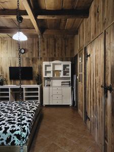 a bedroom with a bed in a room with wooden walls at Apartamenty Góralski DACH NAD GŁOWĄ in Poronin