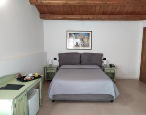 a bedroom with a large bed and a desk at Villa Scaduto Residence in Bagheria