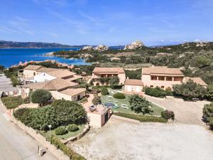 an aerial view of a house with a lake at Hotel Sole Mare in Baja Sardinia