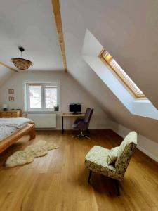 a bedroom with a bed and a desk in a attic at Przysiółek Flądrówka - Dom na odludziu z widokiem na Gorce i Tatry in Szczawa
