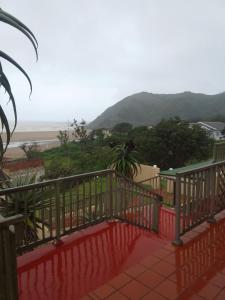 a balcony with a view of the ocean and mountains at Ocean View Guest House in Port St. Johns