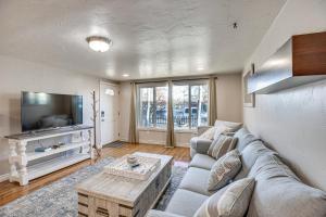 a living room with a couch and a tv at 2 Mi to Dtwn Grand Junction Home with Hot Tub in Grand Junction