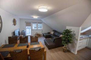 a living room with a table and a couch at High-quality renovated apt (TLA/Tlf/TDY-RAB) in Ramstein-Miesenbach