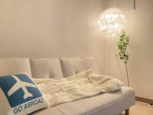a living room with a couch with a go aronto blanket at LC Loft City House in Seoul