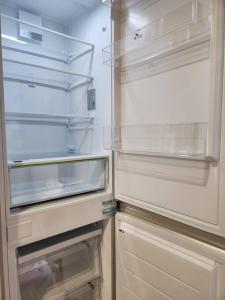 an empty refrigerator with its door open in a kitchen at LC Loft City House in Seoul