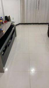 a kitchen with a white tiled floor with a stove at APARTAMENTO IMPERIAL IV (COMPLETO) in Castanhal