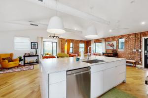 an open kitchen and living room with a brick wall at Encanto Dreams in Phoenix