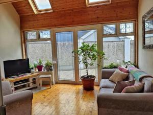 a living room with two couches and a flat screen tv at Entire home at Ballysax House in Newpark