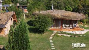 an image of a house with a thatch roof at Wild Cherry Cordwood / Дивите череши in Godech