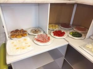 a refrigerator filled with lots of different types of food at TINY ART HOUSE HOTEL near Airport of Samarkand in Samarkand