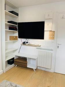 a white desk with a television on top of it at Studio cosy au cœur de Paris in Paris