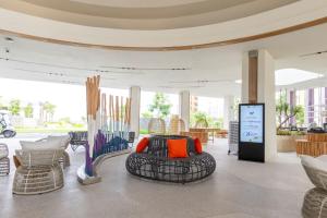 a room with chairs and a ottoman in a building at TTC Van Phong Bay Resort - Himalaya Sauna & Steam Retreat Included in Ninh Hòa