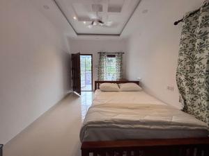 Postel nebo postele na pokoji v ubytování Mali Homestays