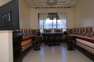 a living room with couches and a flat screen tv at MOHAMMEDIA 101 in Mohammedia