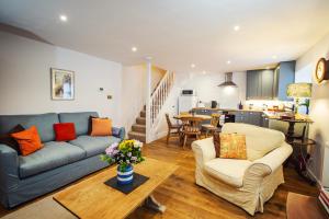 a living room with a blue couch and a table at The Bothy at Oak Farm in Usk