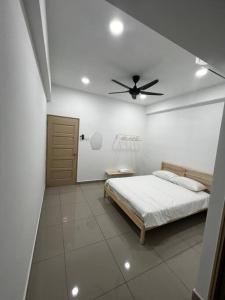 a bedroom with a bed and a ceiling fan at Fuji In Muji in Sitiawan