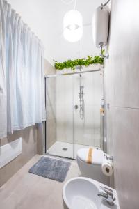 a bathroom with a shower and a toilet and a sink at Kea Home, entire house in the heart of Naples in Naples