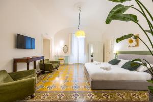 a hotel room with a bed and a living room at Kea Home, entire house in the heart of Naples in Naples