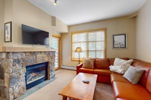 a living room with a couch and a fireplace at Passage Point 506 in Copper Mountain