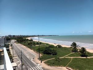 Blick auf den Strand vom Balkon eines Gebäudes in der Unterkunft Paradise Beach Flat in João Pessoa