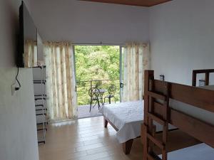 a bedroom with a bed and a view of a balcony at Villas Josipek in Fortuna