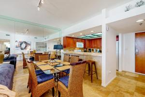 a dining room and kitchen with a table and chairs at East Pass Towers 302 in Destin