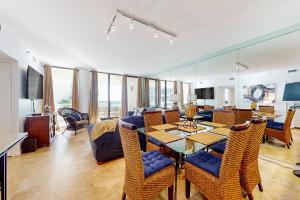 a living room with a table and chairs and a couch at East Pass Towers 302 in Destin