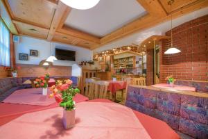 a restaurant with a table with a vase of flowers on it at Margarete Gwehenberger in Kleinarl