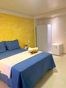 a bedroom with a large bed with blue and white at Hotel Boa Viagem Aeroporto in Recife
