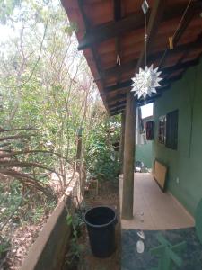 a porch of a house with a chandelier at Chalé Nova Aurora in Alto Paraíso de Goiás