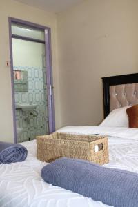 a wicker basket sitting on top of a bed at Zeni apartment in Meru