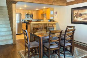 a kitchen and dining room with a table and chairs at Golf Creek 32 in Teton Village