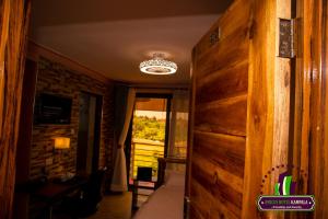 a room with a wooden wall and a room with a window at Amicus Hotel Kampala in Kireka
