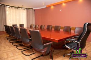 a conference room with a long table and chairs at Amicus Hotel Kampala in Kireka