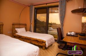 Ein Bett oder Betten in einem Zimmer der Unterkunft Amicus Hotel Kampala